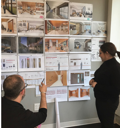 Design critique with images pinned to the wall